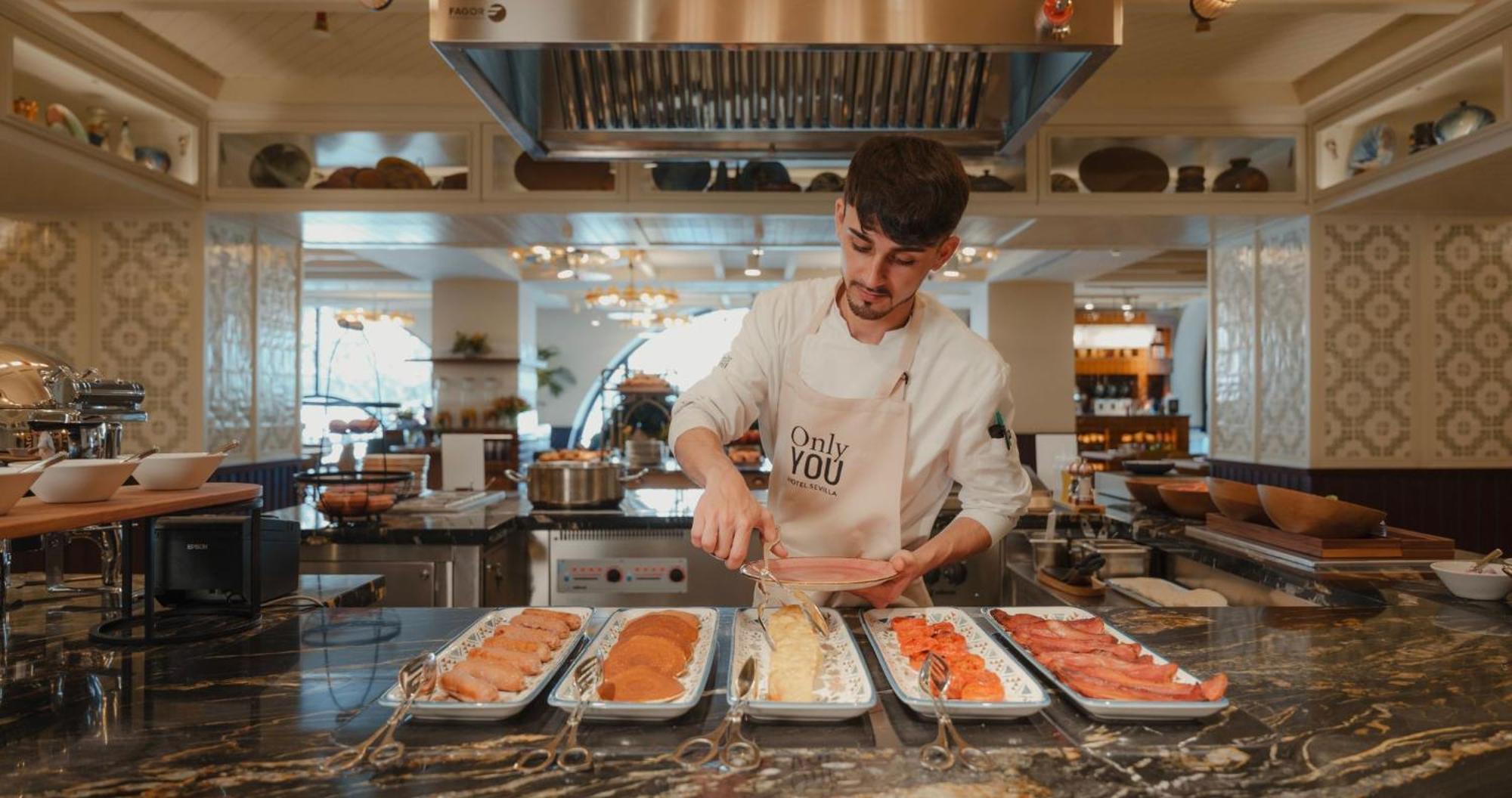 Only You Hotel Sevilla Zewnętrze zdjęcie A chef preparing food